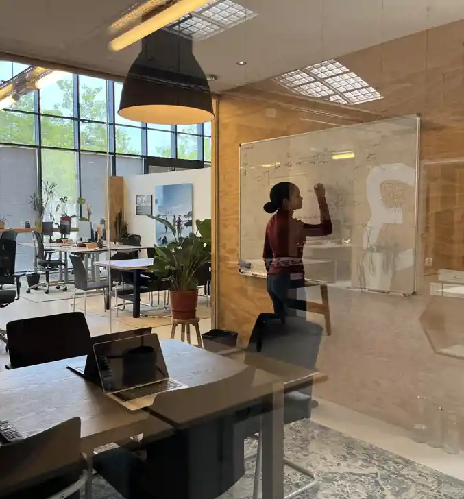 Collega van The Value Department schrijvend op whiteboard op kantoor